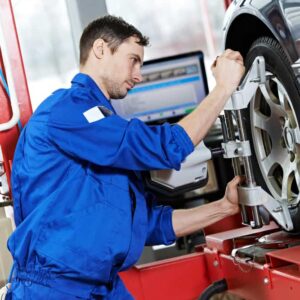 Car Mechanic Installing Sensor During Suspension Adjustment And Automobile Wheel
