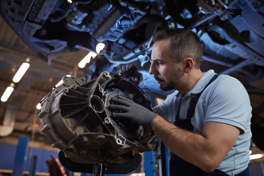 Dramatic,Low,Angle,Portrait,Of,Muscular,Car,Mechanic,Inspecting,Car